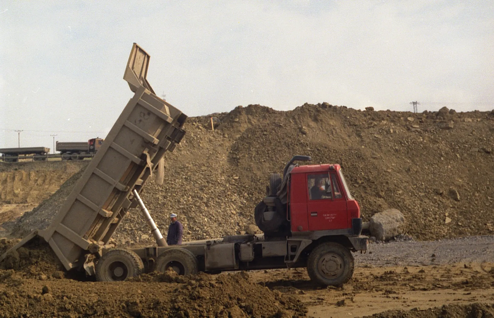 Dump truck and loader hauling and placing fill dirt at a job site in Benton County, Arkansas