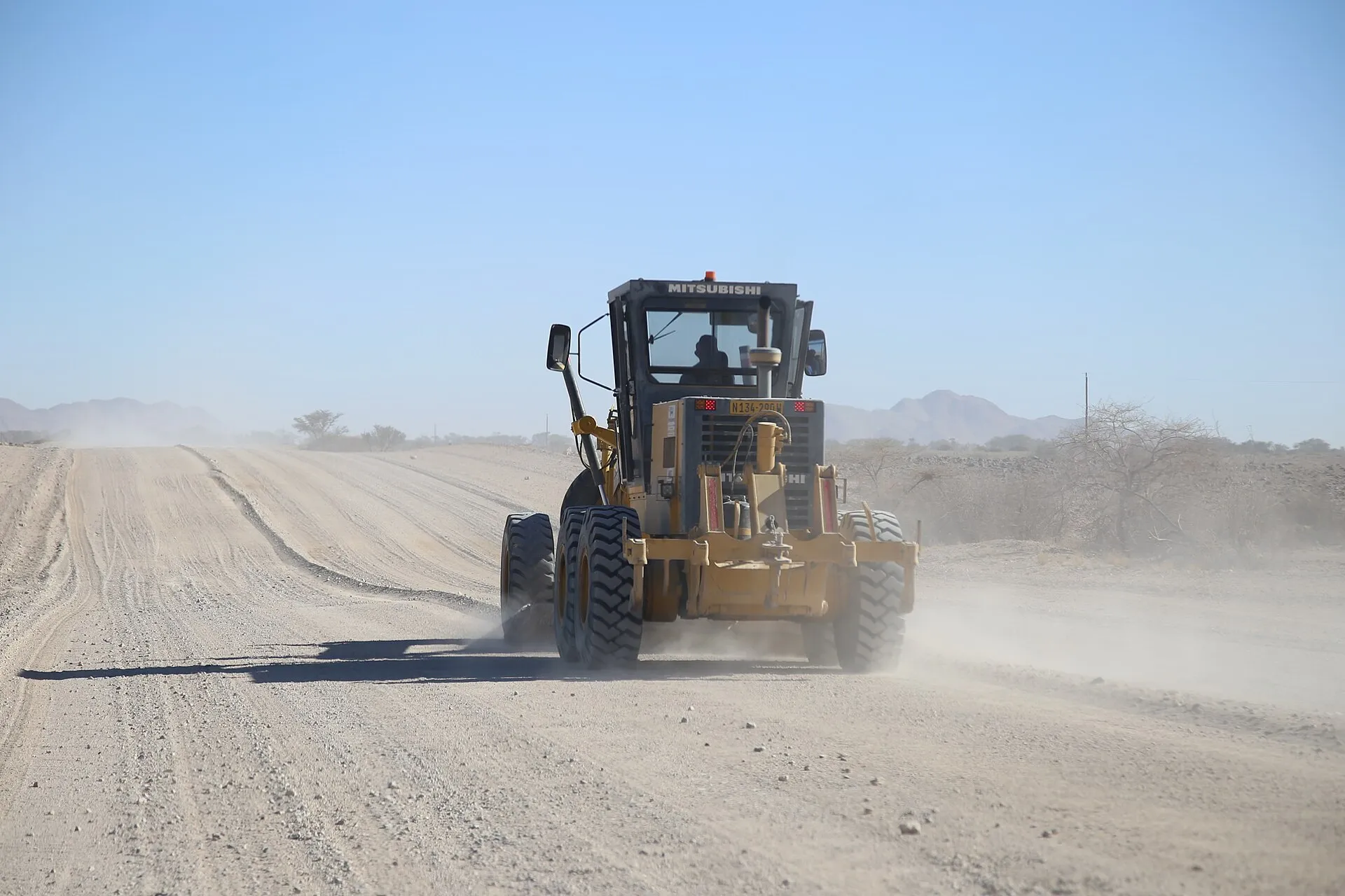 Dozer grading and leveling a sloped residential lot in Benton County, Arkansas